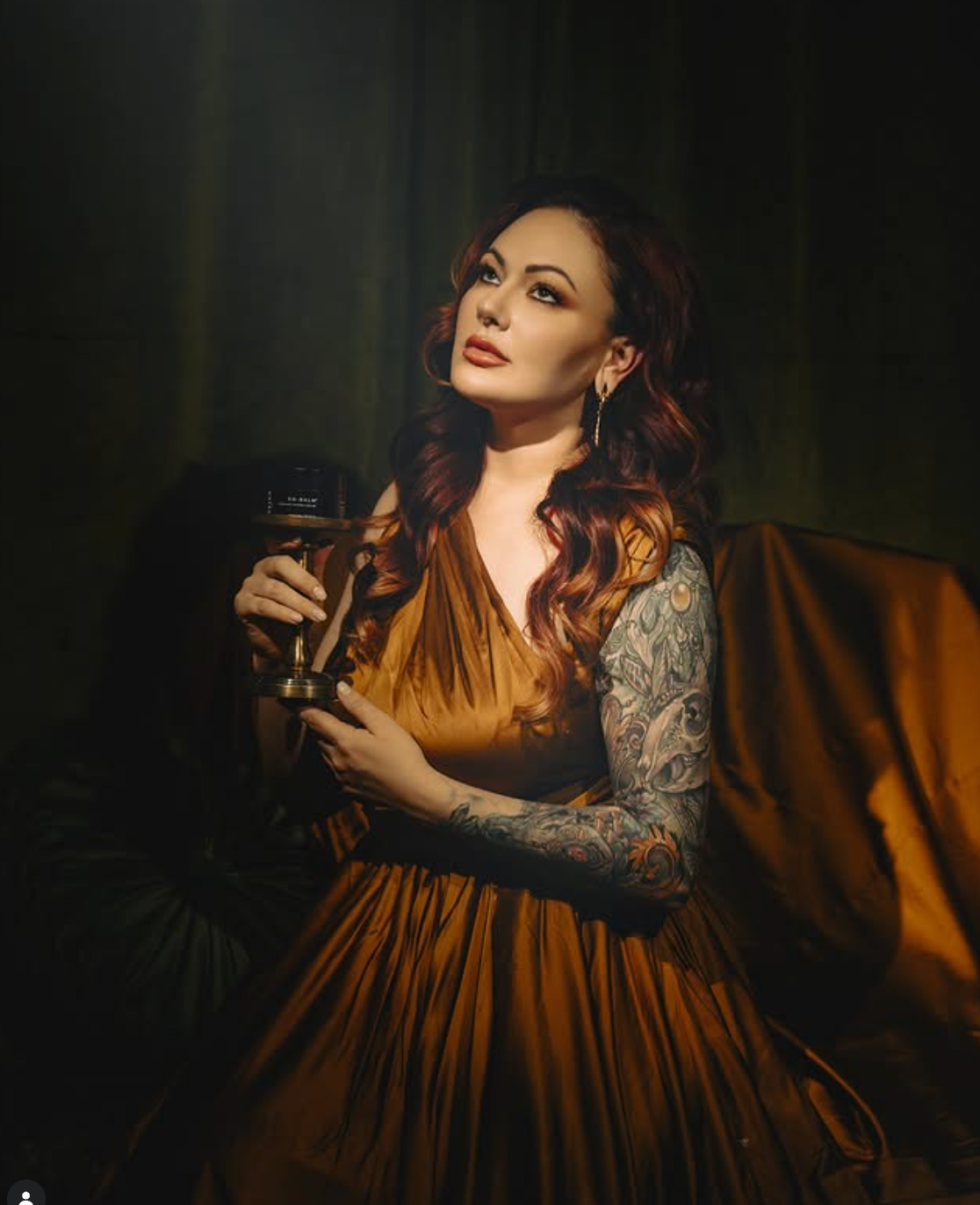 Leigh Ann, founder of Veiled Aesthetics, in a candlelit portrait